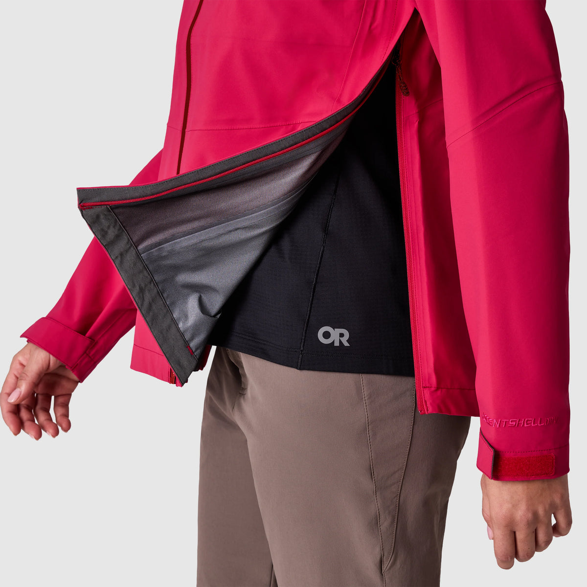 Red rain jacket opened to show dark inner lining and interior pocket
