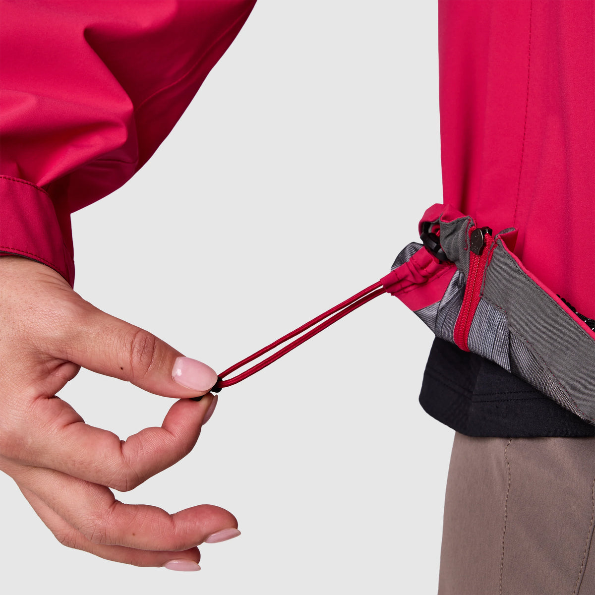 Red rain jacket hem with adjustable drawcord toggle