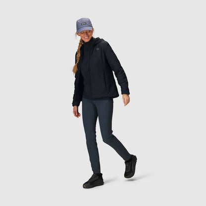 Full-body view of a woman wearing a black insulated hoodie with a hood and zip front