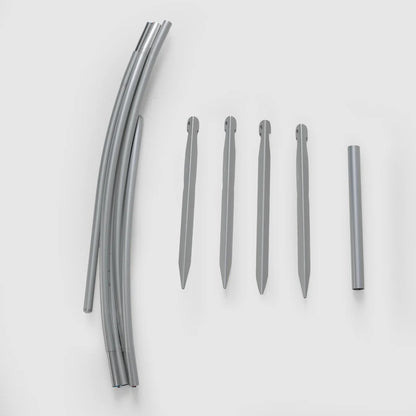 Bivy shelter pole segments and four gray stakes laid out