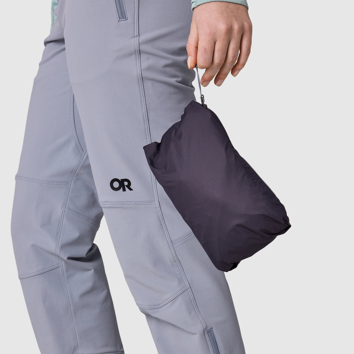 Dark shell jacket packed into its compact stuff sack