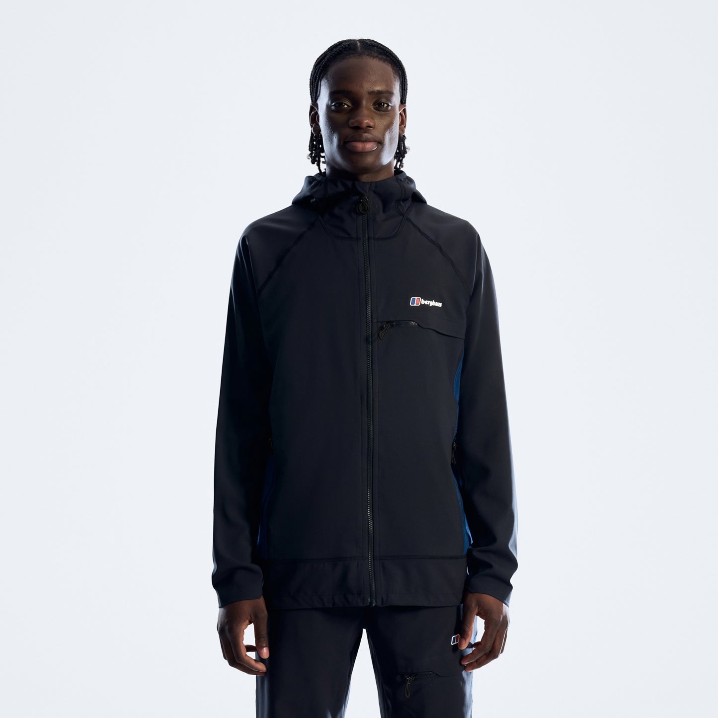 Person wearing a black jacket with a brand logo on a white background