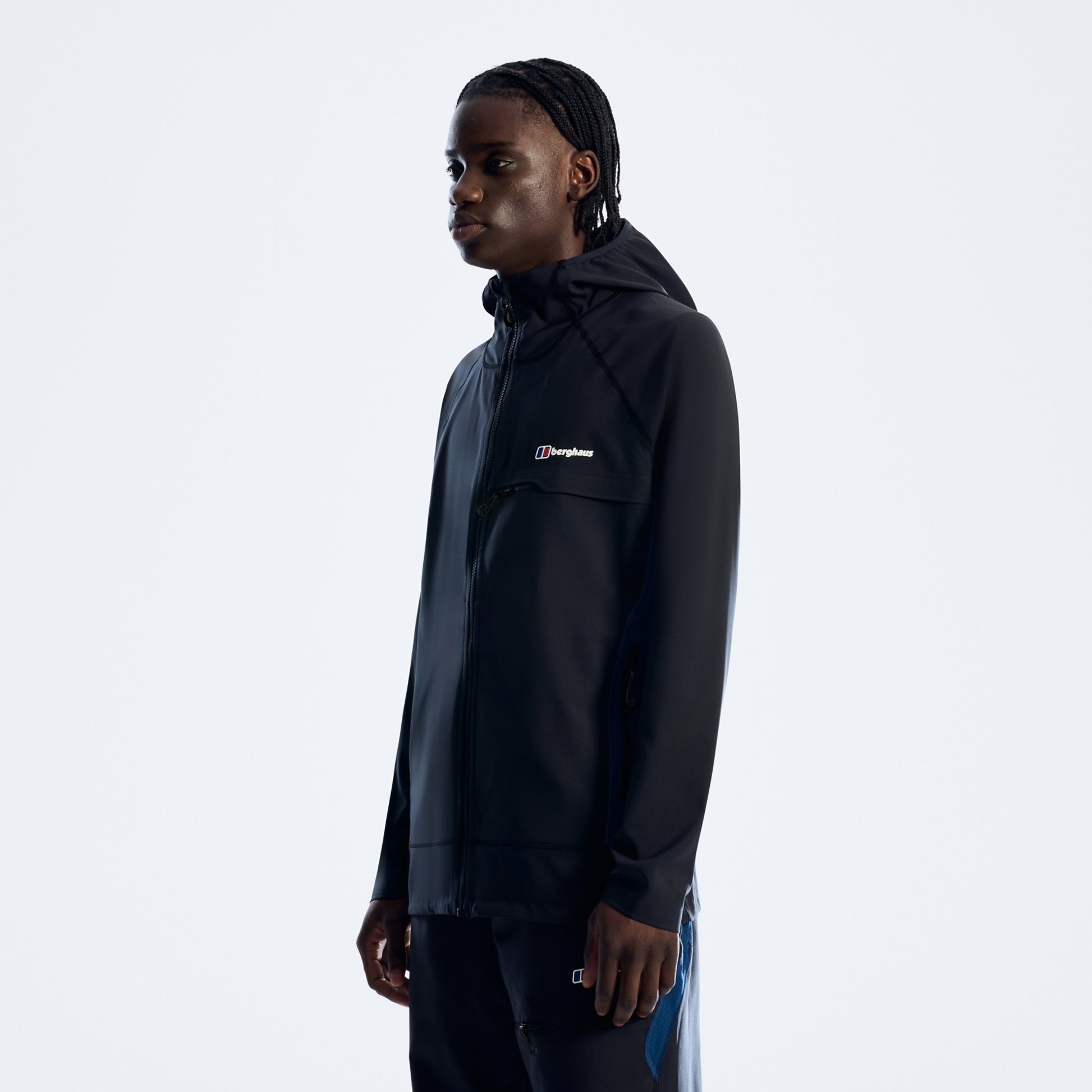 Person wearing a black jacket with a brand logo on a white background