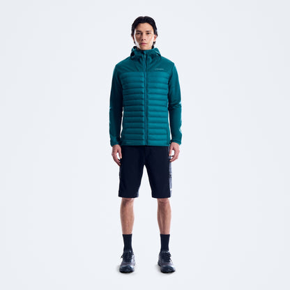 Person wearing a teal puffer jacket on a white background