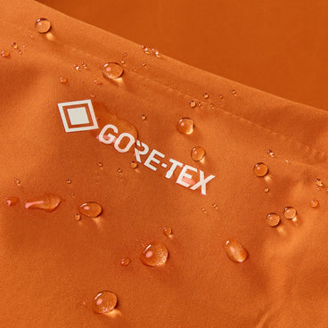 Water-repellent orange fabric with GORE-TEX logo and raised droplets