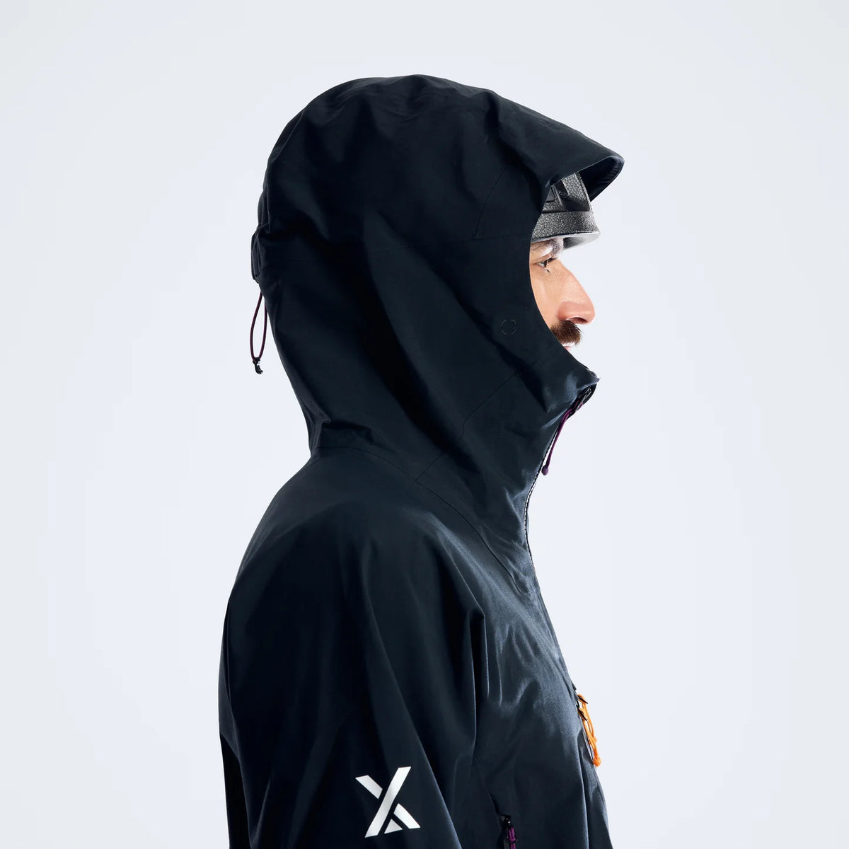Black waterproof hooded jacket, side profile with taped seams and front zip