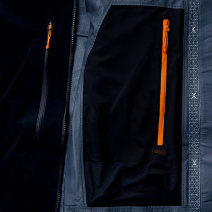 Black jacket interior with orange zip pocket and light gray lining