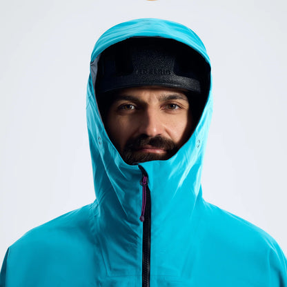 Blue hooded waterproof jacket with black face opening and center zip close-up