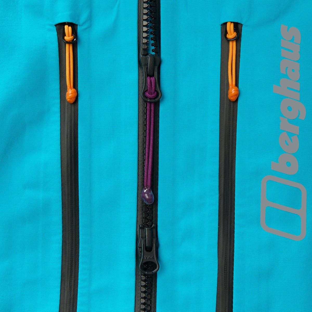 Blue jacket zipper with orange pull and purple cord, waterproof shell detail