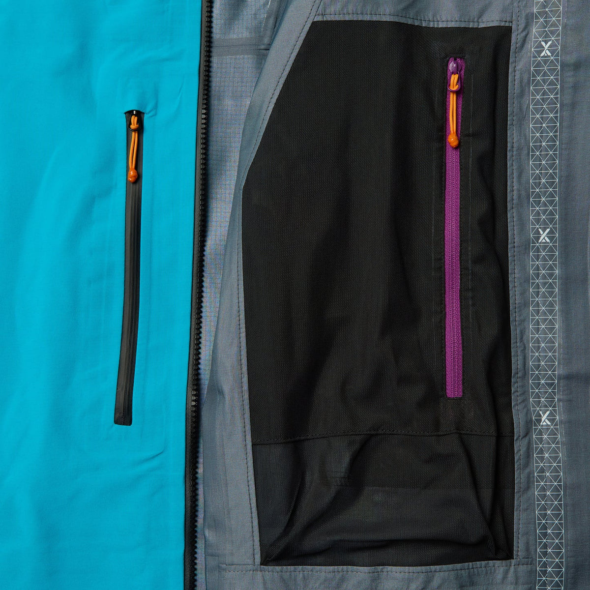 Black inner pocket panel with purple zipper and orange pull, waterproof jacket