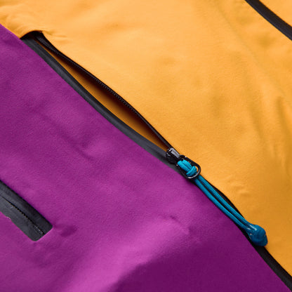Close-up of jacket zipper with blue pull cord and purple interior lining