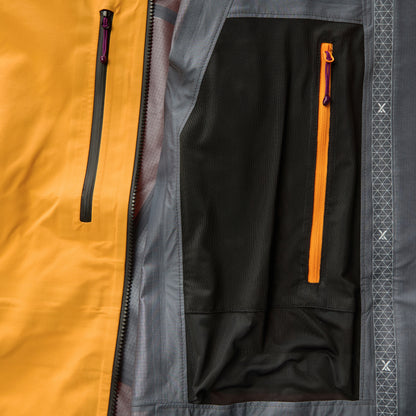 Orange waterproof jacket interior view with black zipper and pocket openings