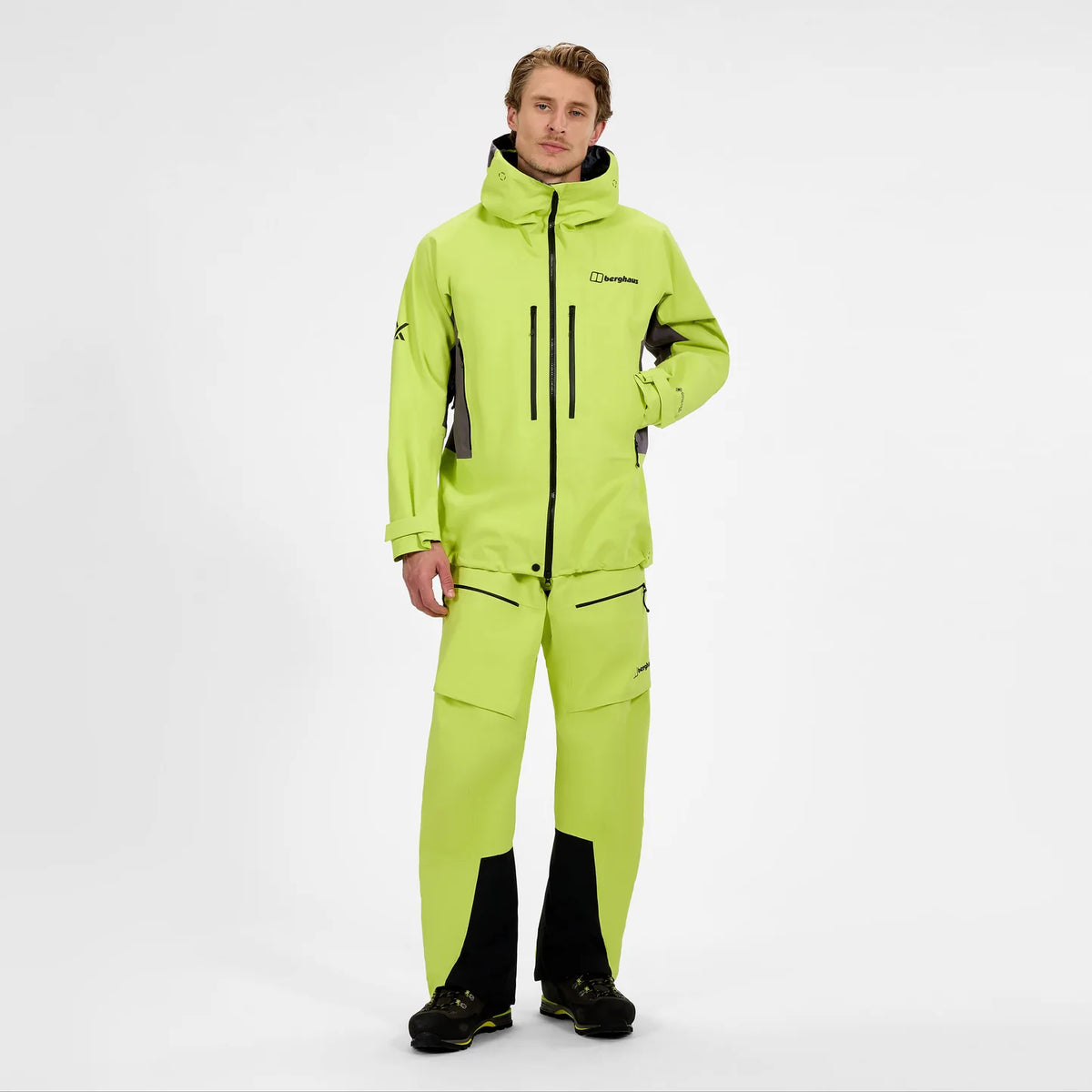Men's neon yellow waterproof jacket with hood, zip front, and matching pants worn