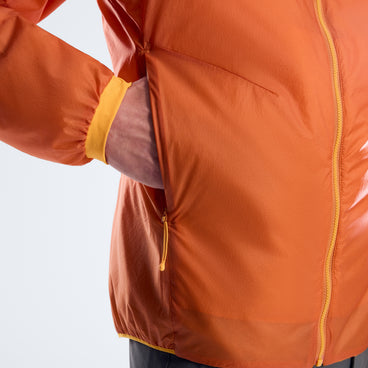 Men's orange insulated jacket sleeve and pocket detail with yellow cuff trim