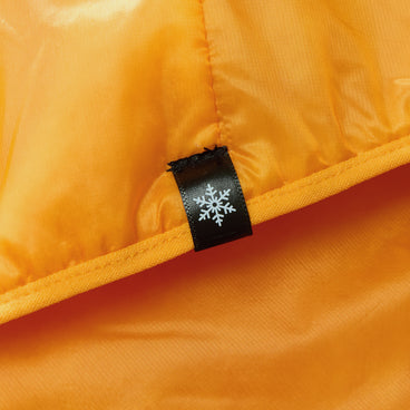 Orange insulated jacket close-up of logo label on zipper trim