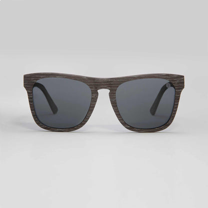 Polarized sunglasses with dark woodgrain frame and black lenses.