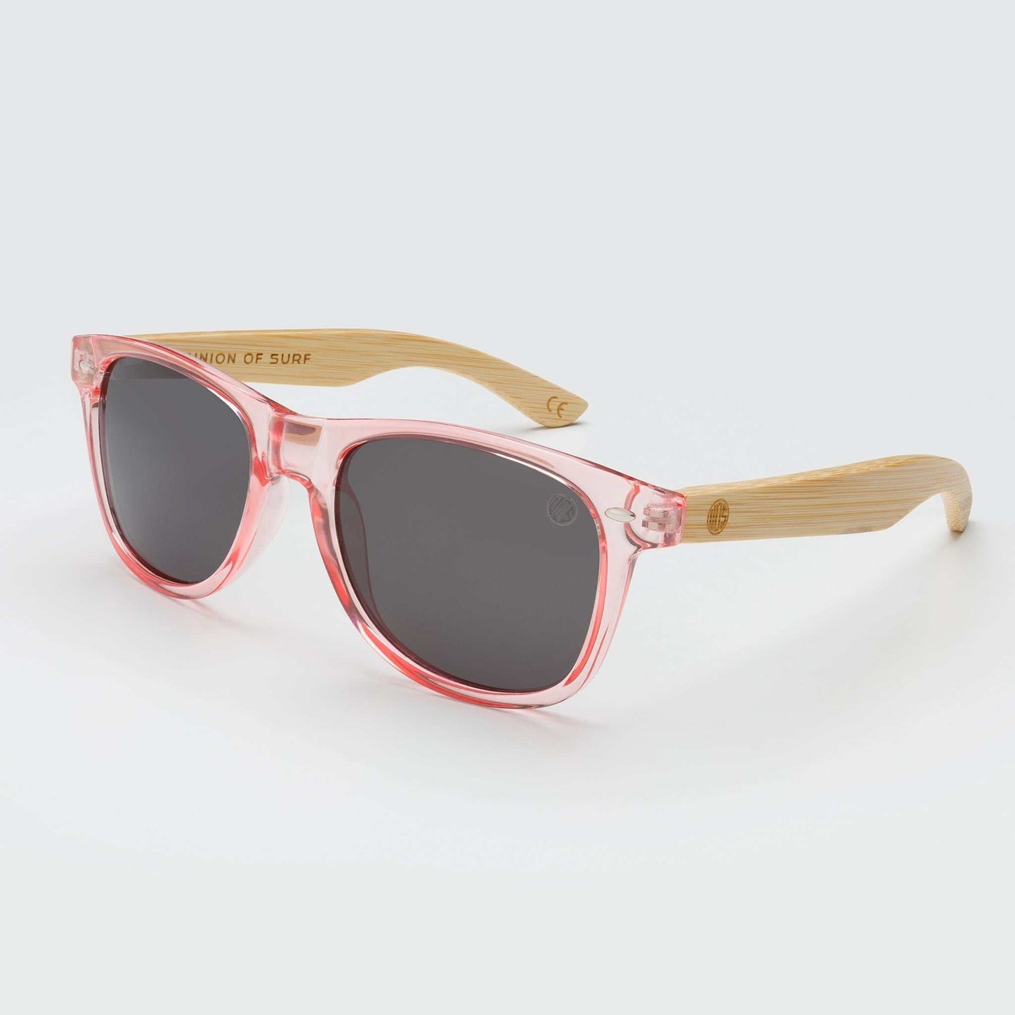 Translucent pink cat-eye sunglasses with dark lenses and bamboo-look arms