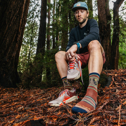 Men's micro crew hiking socks on legs, brown/navy animal graphic with stripes