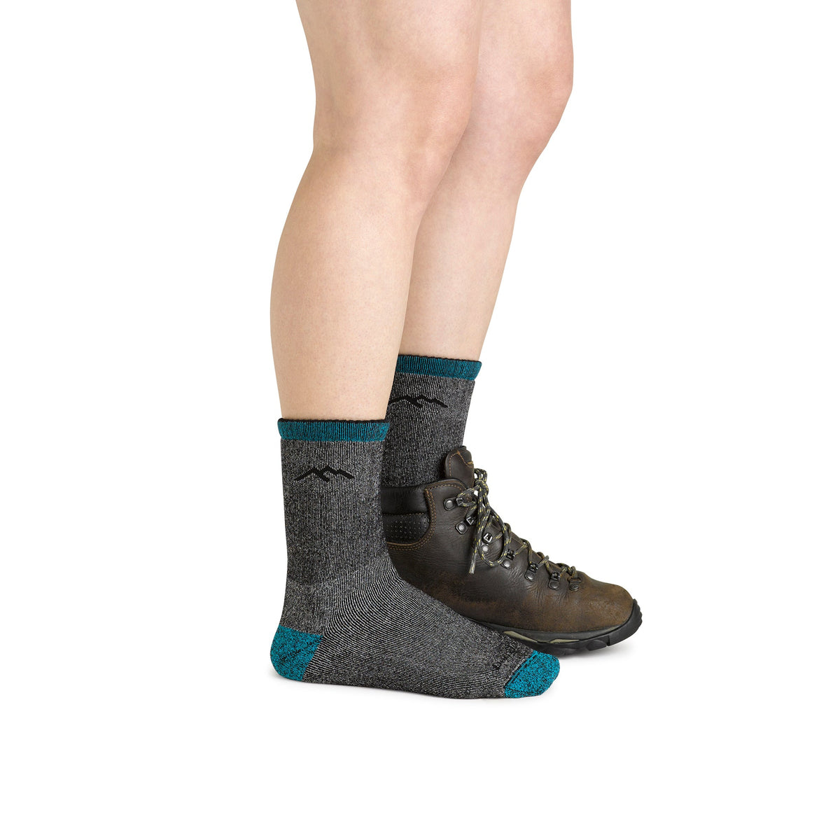 Pair of dark gray merino hiking socks with blue trim, worn with hiking shoes