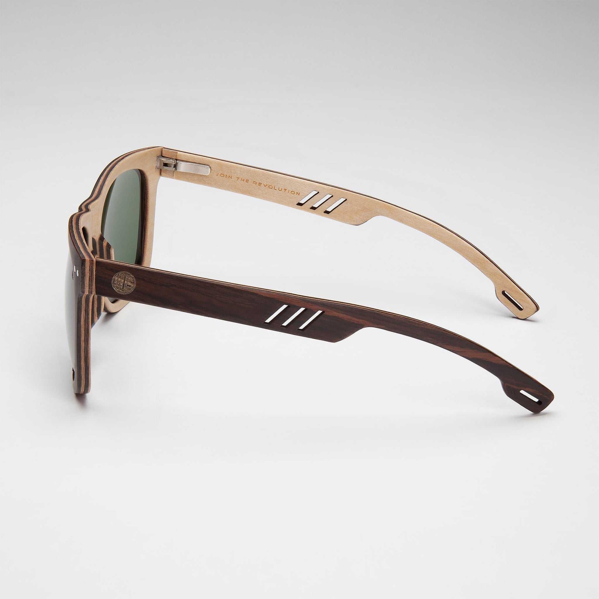 Side view of brown sunglasses with green lenses and metal temple details