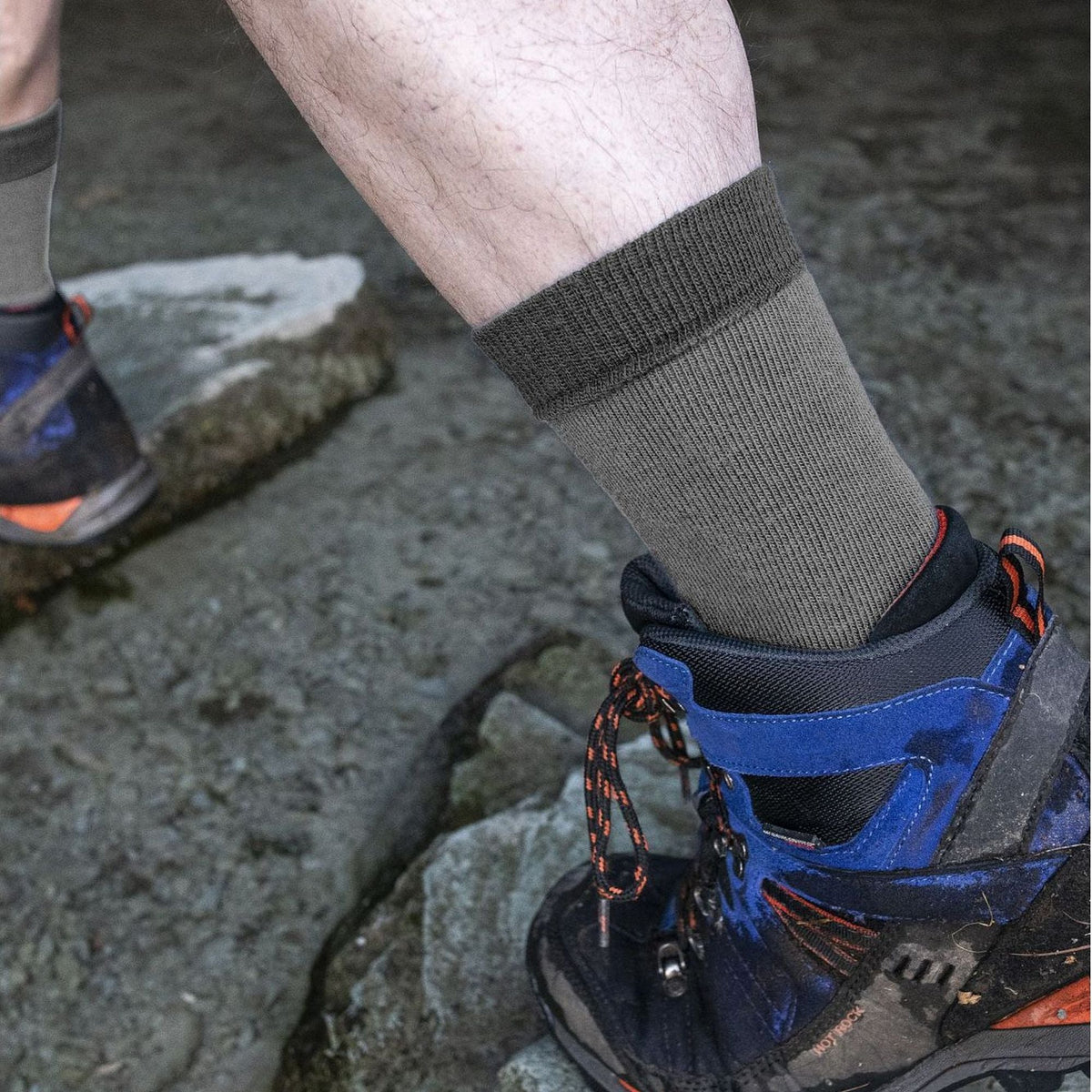 Grey men's liner boot socks, ribbed cuff worn with hiking shoes