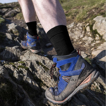Black men's liner boot socks, ribbed cuff worn with hiking shoes