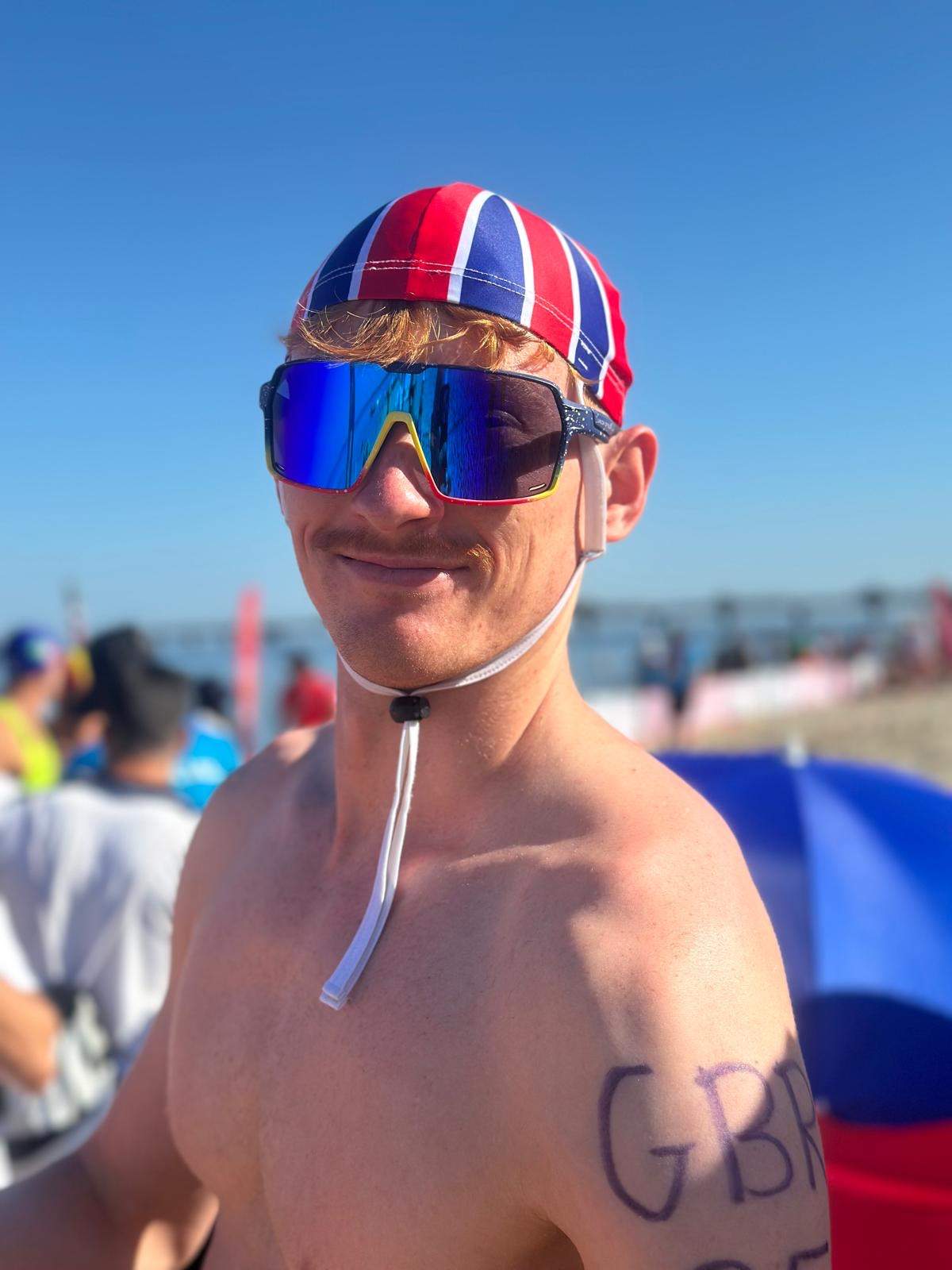 Person wearing wraparound sports eyewear with blue frames and multicolour mirrored lenses