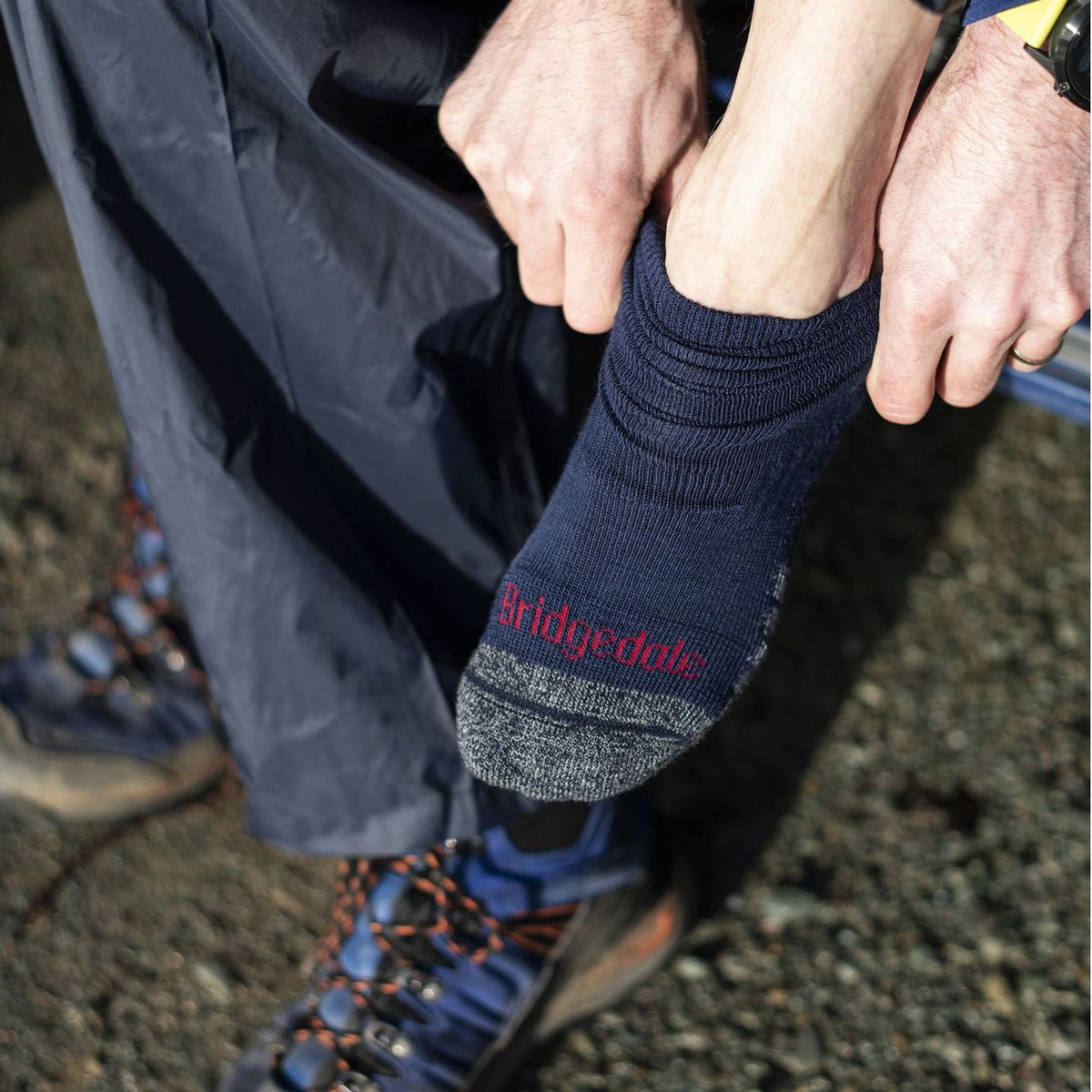 Navy men's merino boot socks with ribbed cuff, worn with lace-up hiking shoes