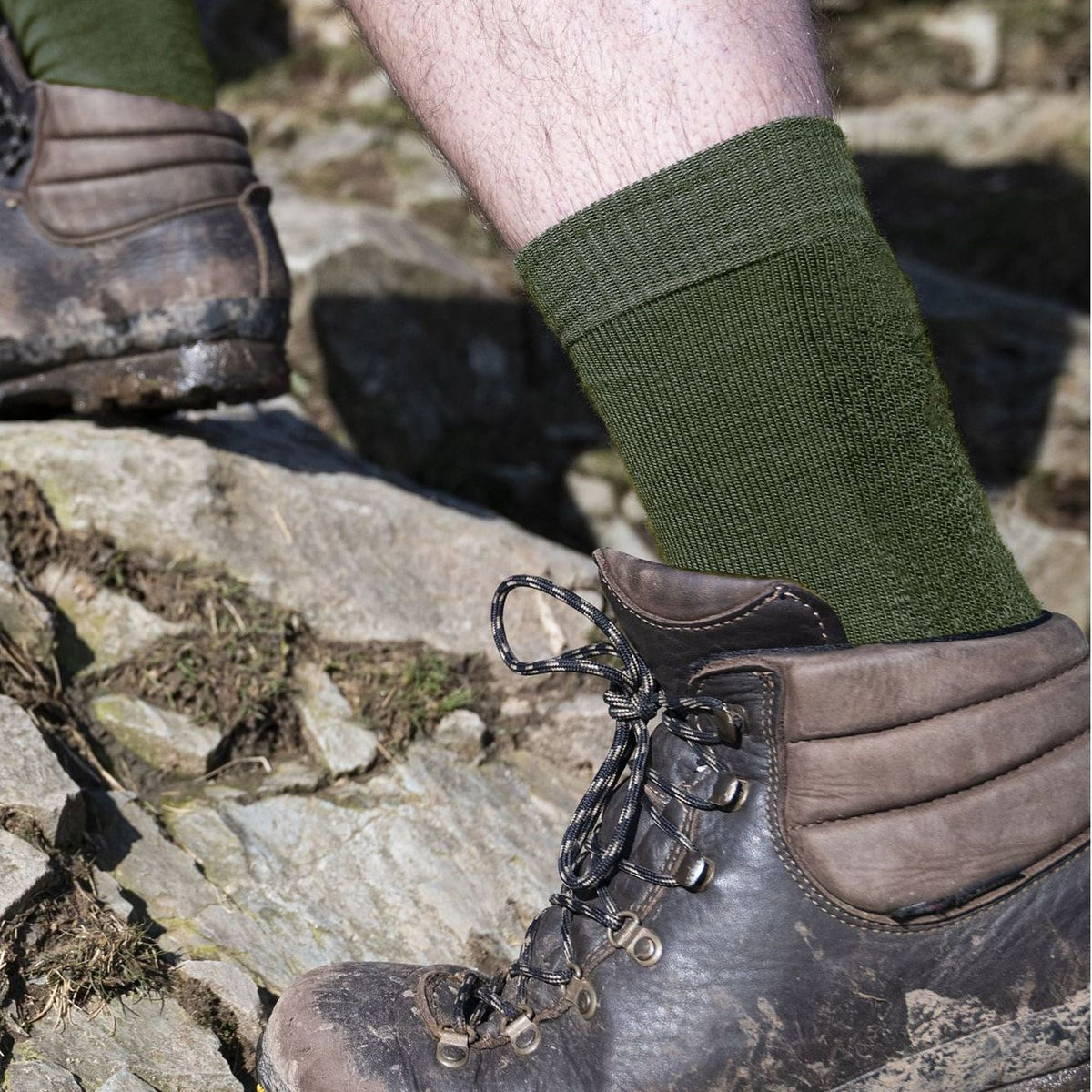 Olive merino wool boot socks on feet with ribbed crew knit