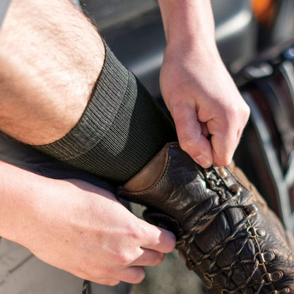 Mens charcoal hiking boot socks, ribbed cuff, close-up with leather boot
