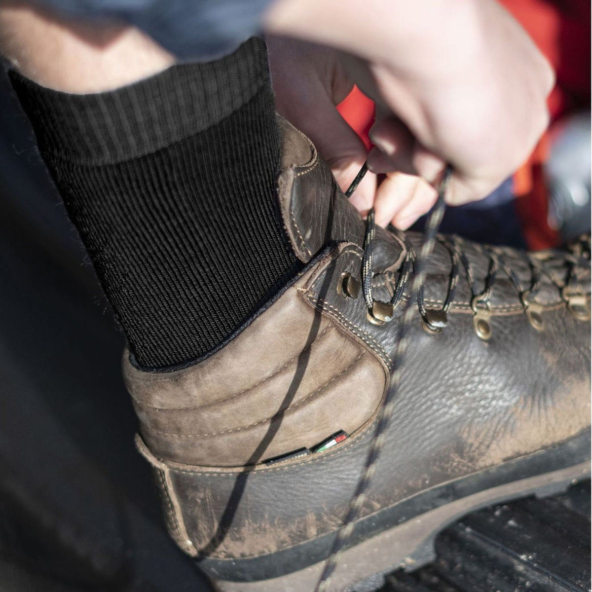 Mens black hiking boot socks with ribbed crew cuff, close-up
