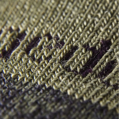 Close-up of olive and dark knit sock texture with purple stitch stripe