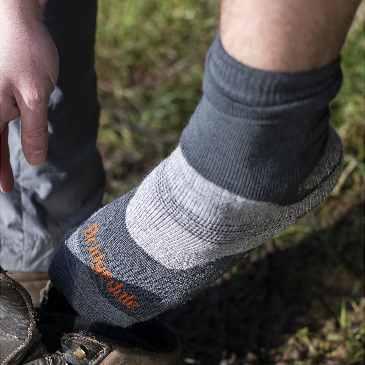Mens hiking boot sock in gray with dark heel and toe, orange Bridgedale logo