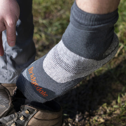 Men’s midweight merino hiking boot socks, dark gray with orange logo text at ankle