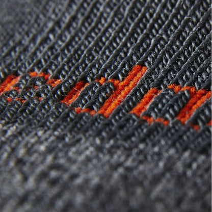 Close-up of dark knit boot socks with orange accent stripe stitching