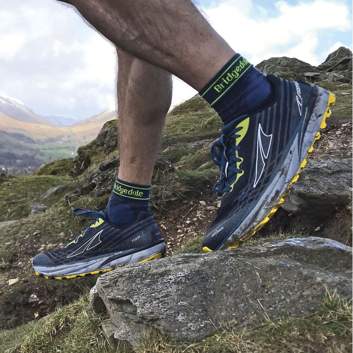 Men's blue crew trail socks with green Bridgedale logo and neon accents