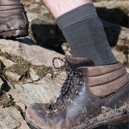 Dark grey merino hiking boot socks worn with lace-up boots