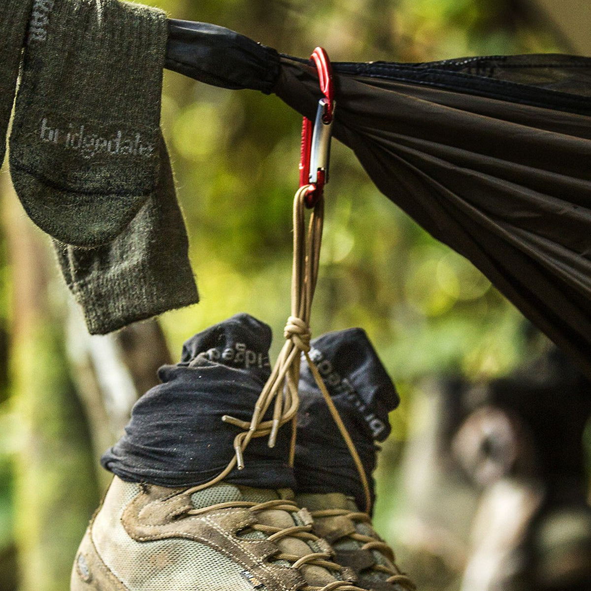 Hiking sock on foot with trail boot, dark green crew height
