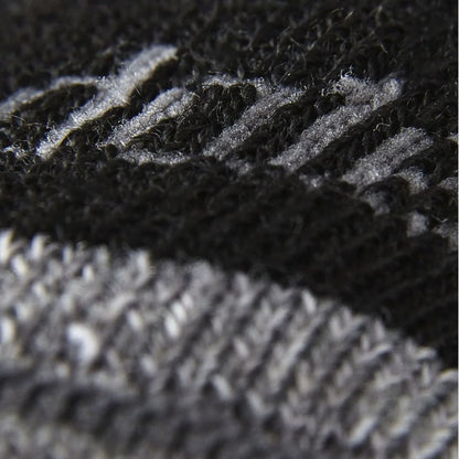 Close-up of ribbed knit hiking sock, dark fabric with gray cushion sections