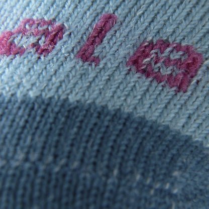 Light blue knit sock fabric with pink-red and blue embroidered logo detail