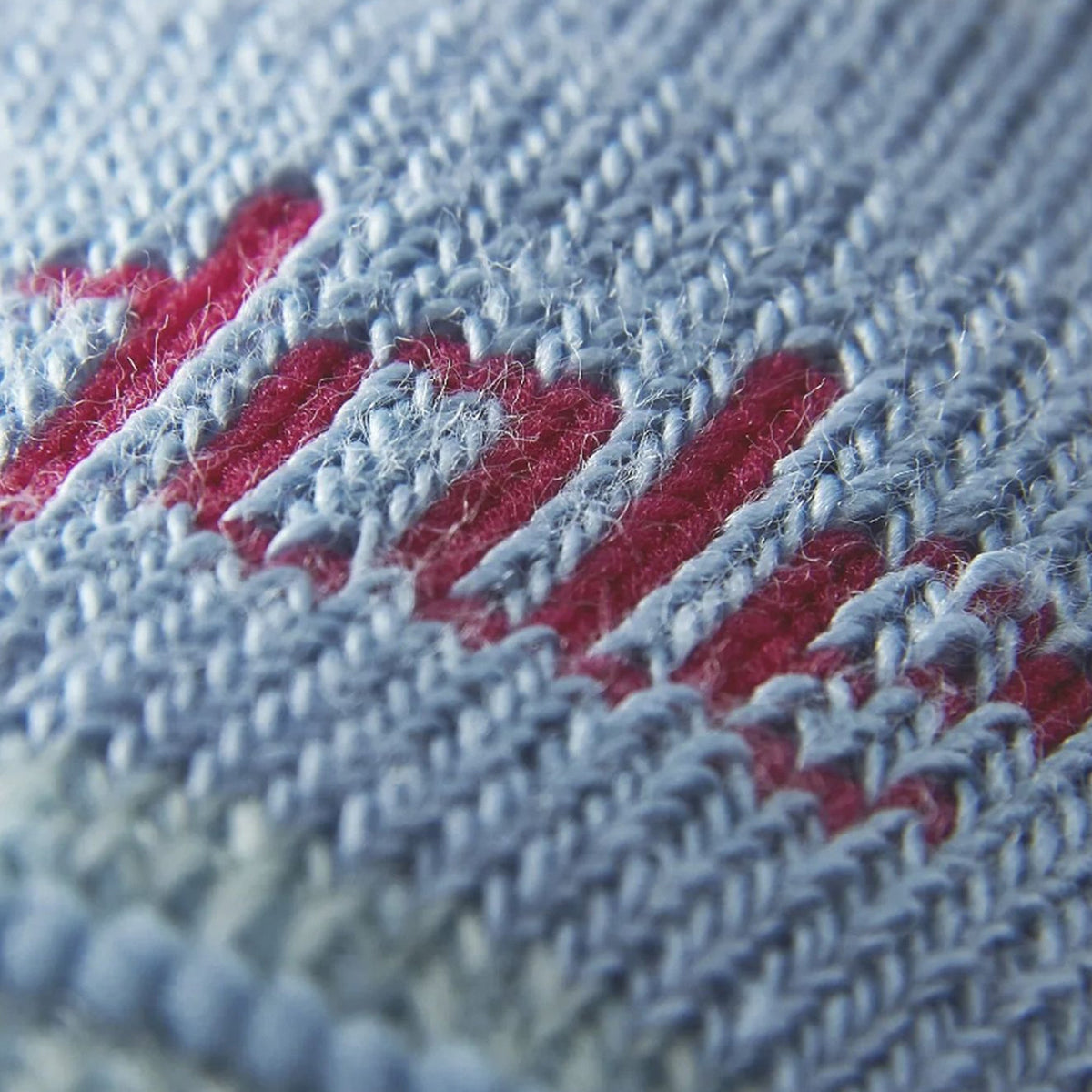 Lightweight merino hiking sock close-up, powder blue knit with red logo