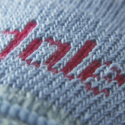Lightweight merino hiking sock close-up, powder blue knit with red logo