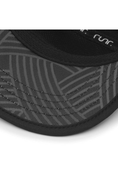 Black running cap brim close-up with patterned side panels and curved stitching
