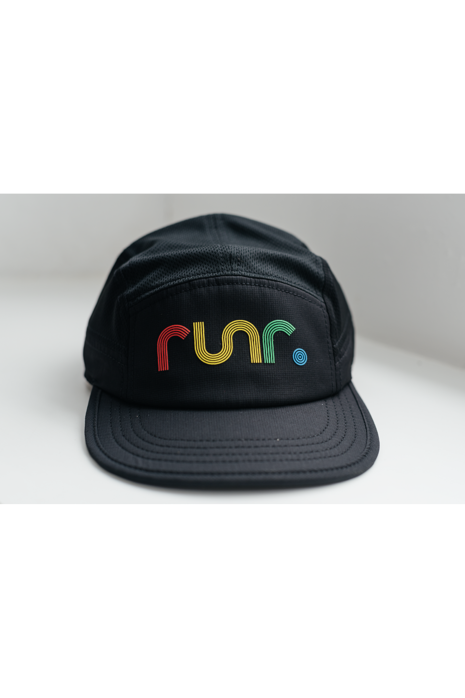Black technical running cap with multicolor "run" logo centered on front
