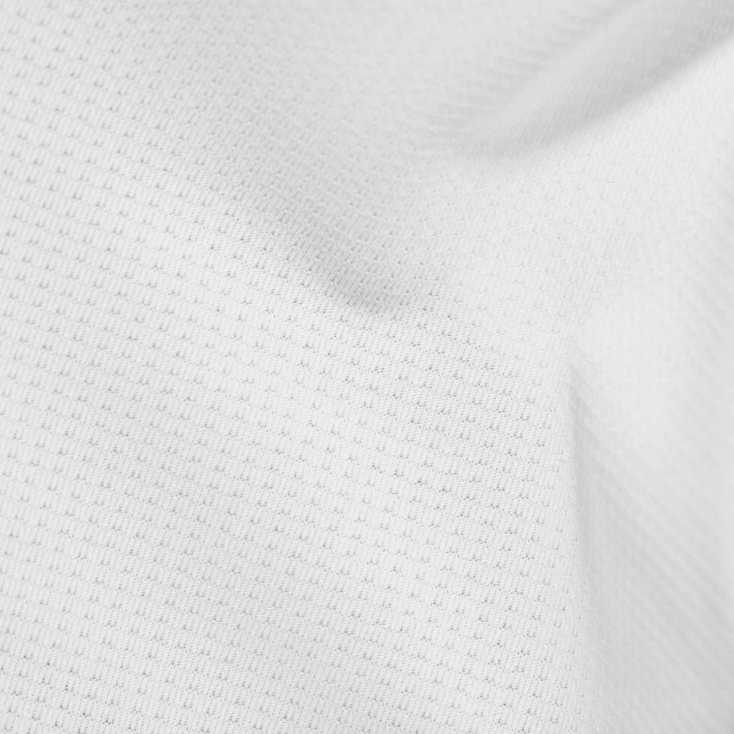 White performance knit T-shirt fabric close-up with tight textured weave.