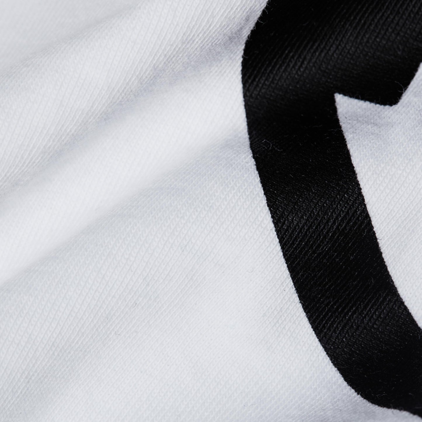 White men's crewneck T-shirt with black graphic print detail close-up