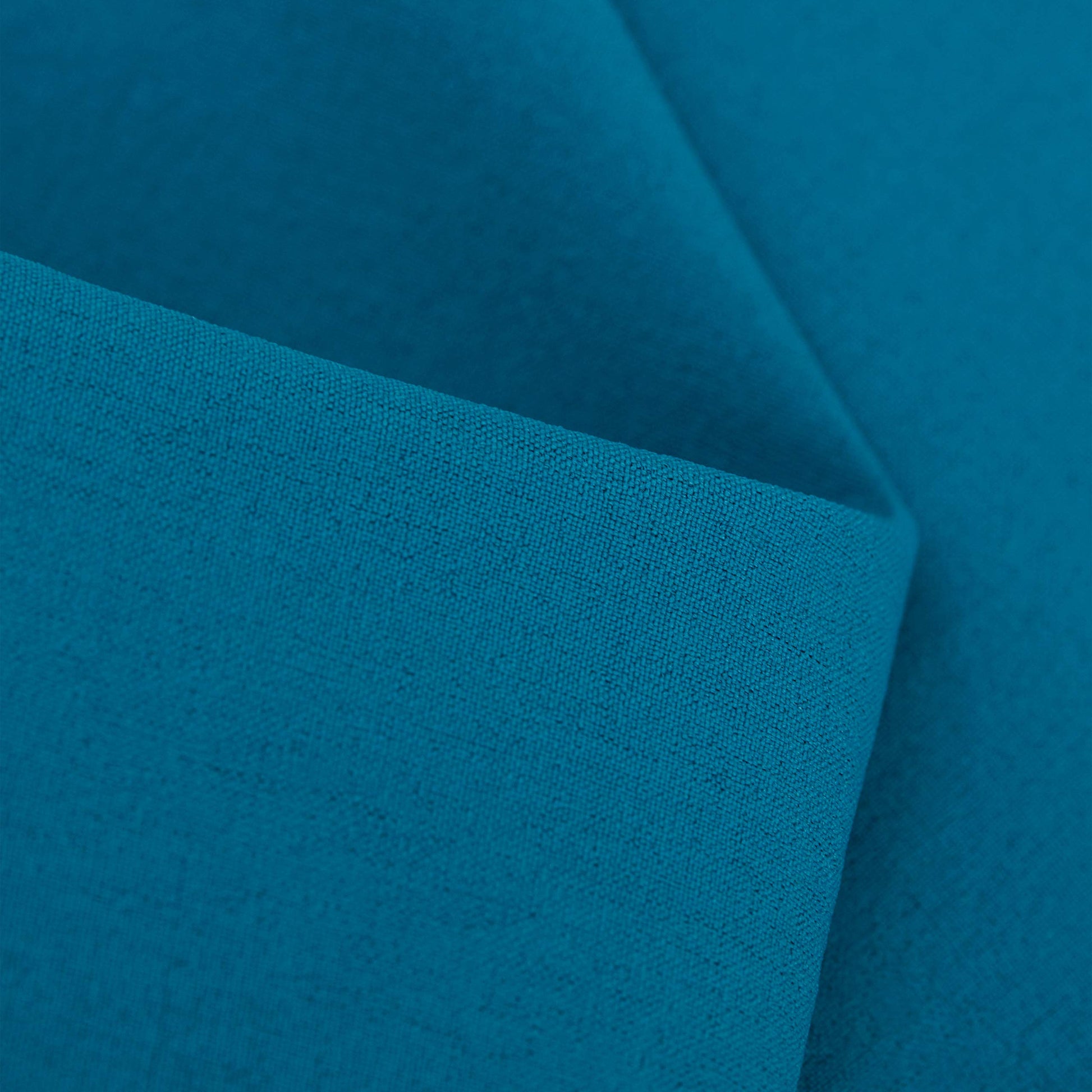 Close-up of teal blue fabric texture on men's trail running shorts.