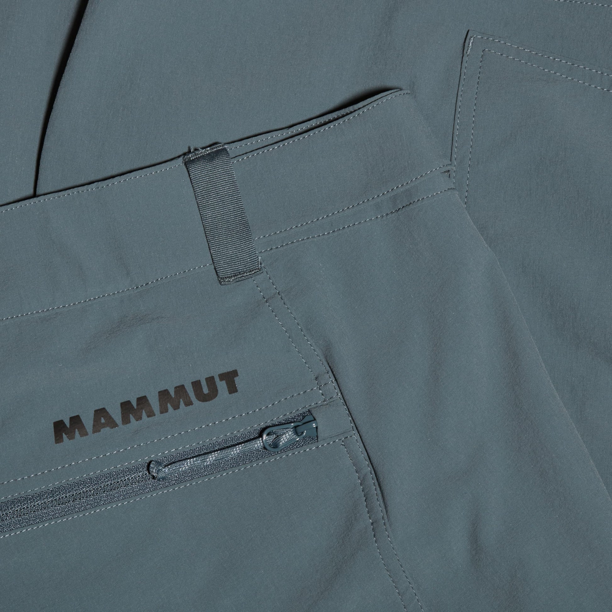Mammut men's trail running shorts, light blue fabric with logo patch and zip pocket