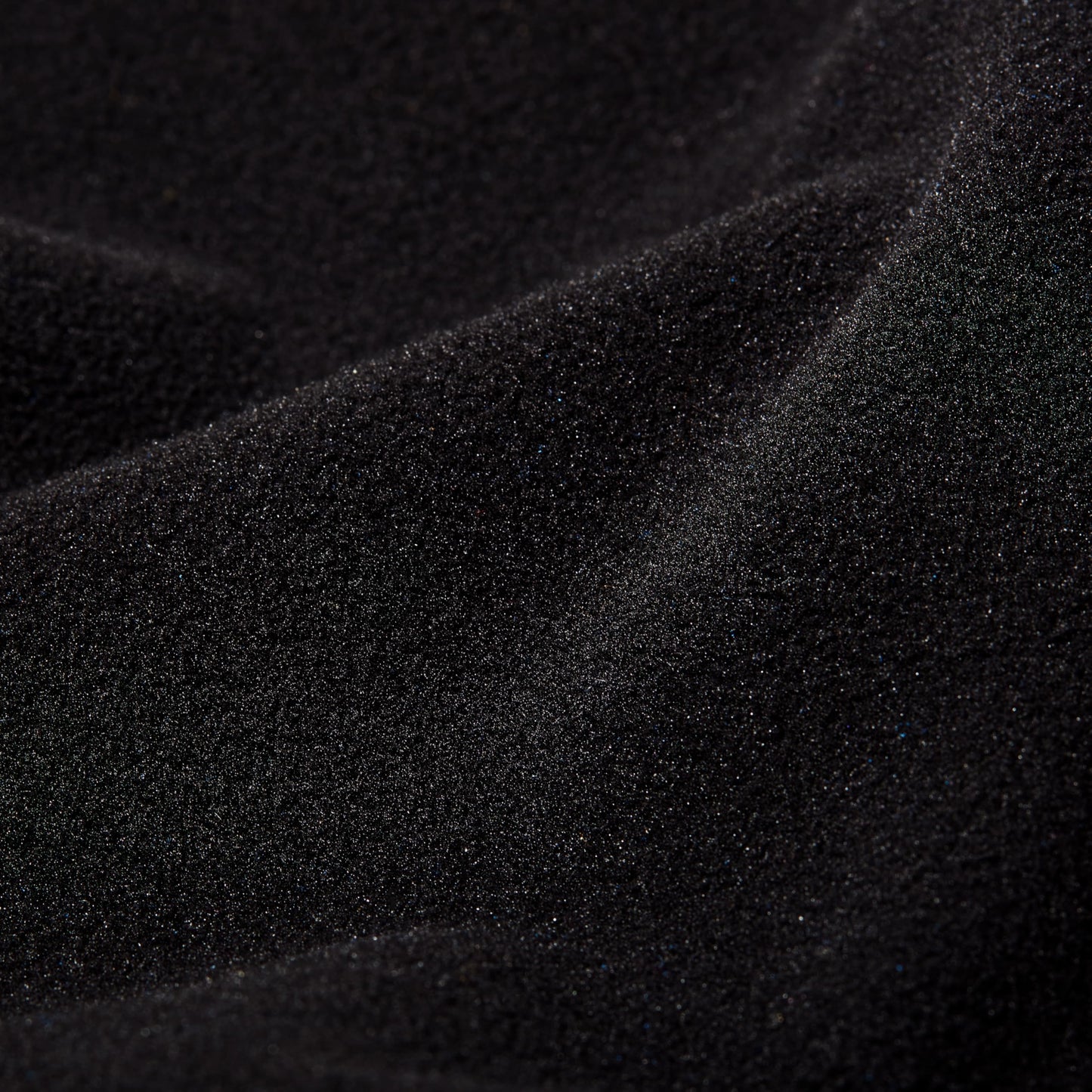 Close-up of black fleece fabric with subtle knit texture