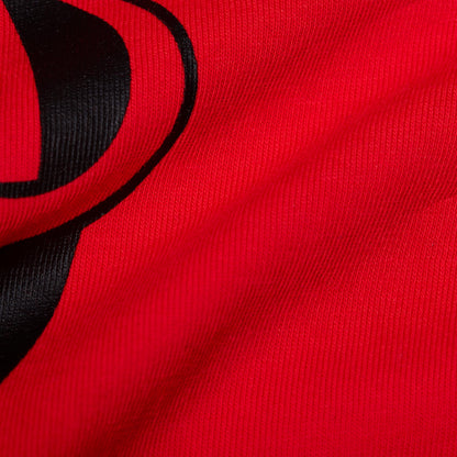 Red T-shirt knit fabric with black graphic logo print close-up